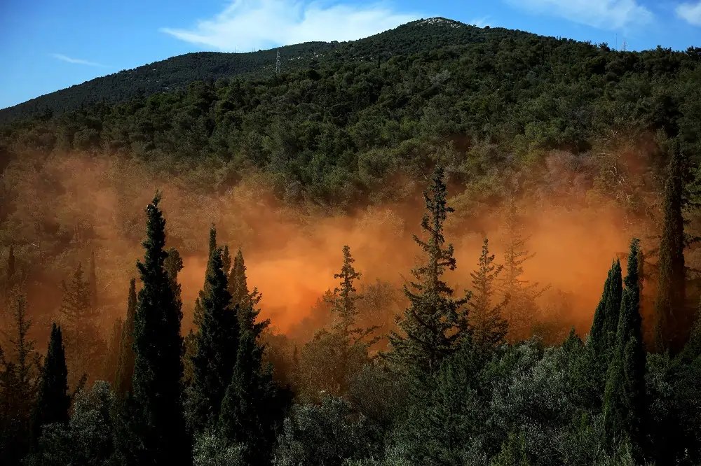 Firefighters battling a wildfire in Greece, highlighting summer wildfire threats - Global Banking & Finance Review