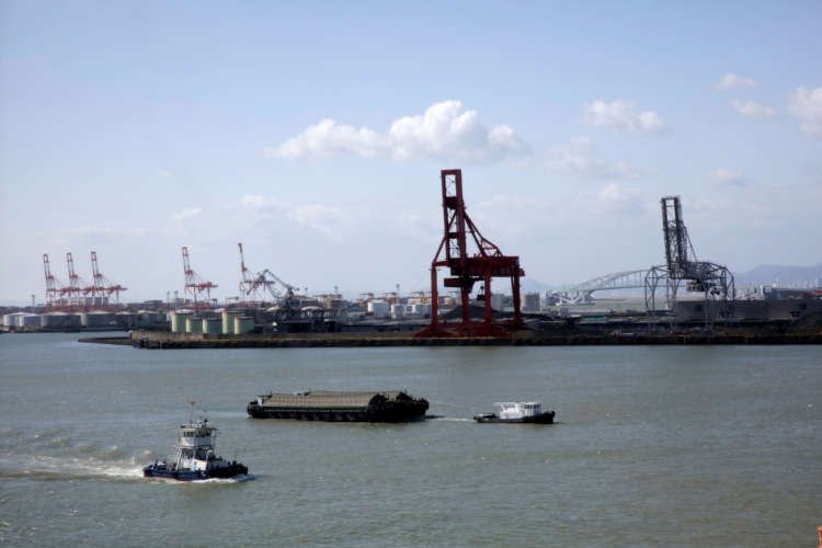 Industrial output rise in Japan with barge transporting goods - Global Banking & Finance Review