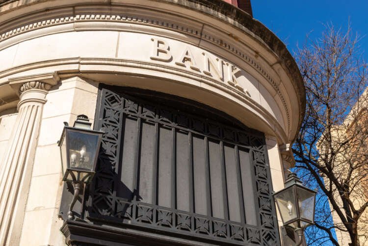 Old bank building representing traditional banking challenges in a fintech world - Global Banking & Finance Review