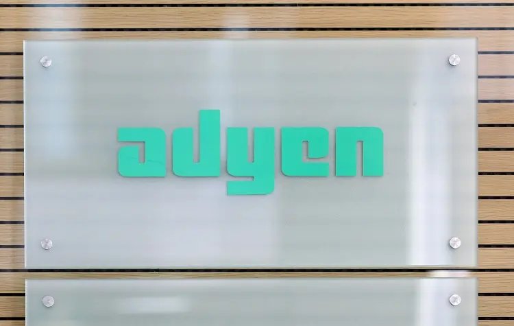 Adyen's logo displayed with a financial chart showing revenue trends - Global Banking & Finance Review