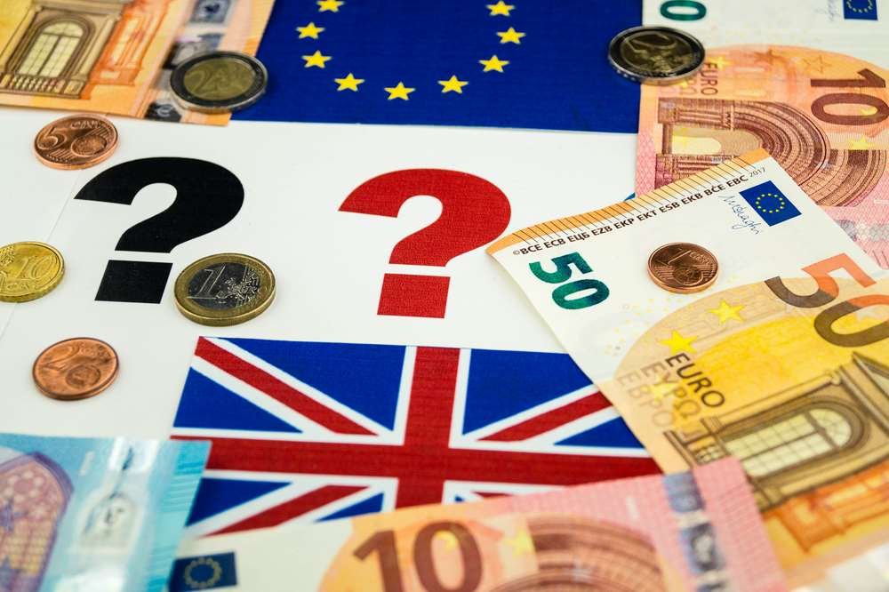 Financial analyst reviewing sanctions and money laundering rules post-Brexit - Global Banking & Finance Review