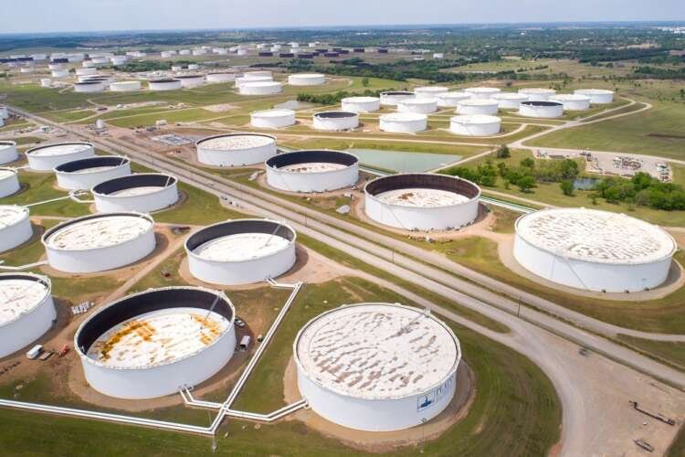 Aerial view of crude oil storage tanks highlighting the oil market's volatility - Global Banking & Finance Review