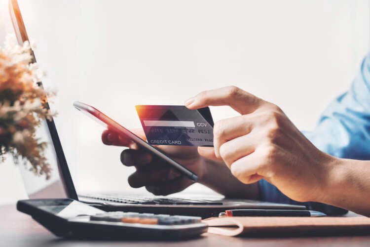 Person using electronic payment technology for online shopping - Global Banking & Finance Review
