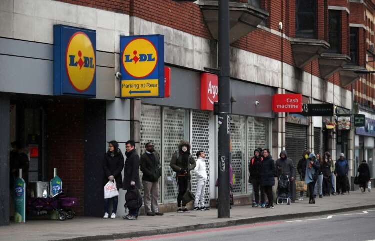 People queue outside Lidl supermarket in London, highlighting UK store expansion - Global Banking & Finance Review