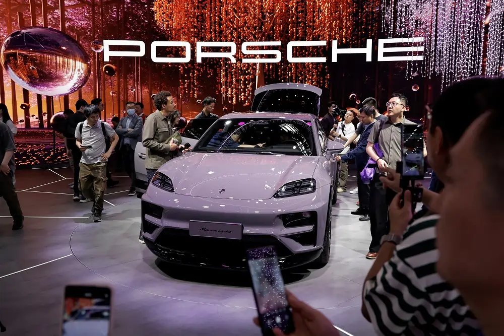 Porsche AG logo with declining stock graph, illustrating the impact of alloy shortage - Global Banking & Finance Review