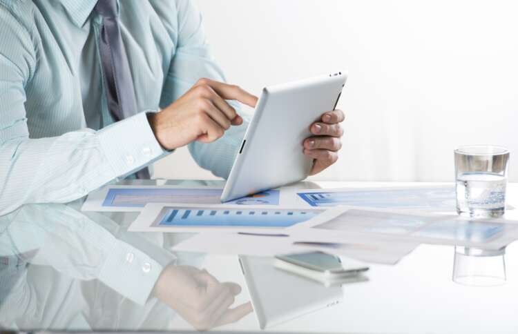 Business professionals analyzing graphs and charts for ESG and financial reporting - Global Banking & Finance Review