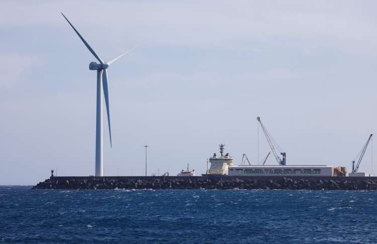 Wind turbine by Siemens Gamesa at Arinaga beach, illustrating challenges in renewable energy sector - Global Banking & Finance Review