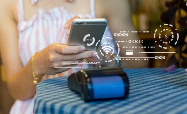 close up customer woman hand turn on wifi in mobile and using contactless payment application by smartphone to paying money in credit card to machine in the cafe shop , millennial and technology concept