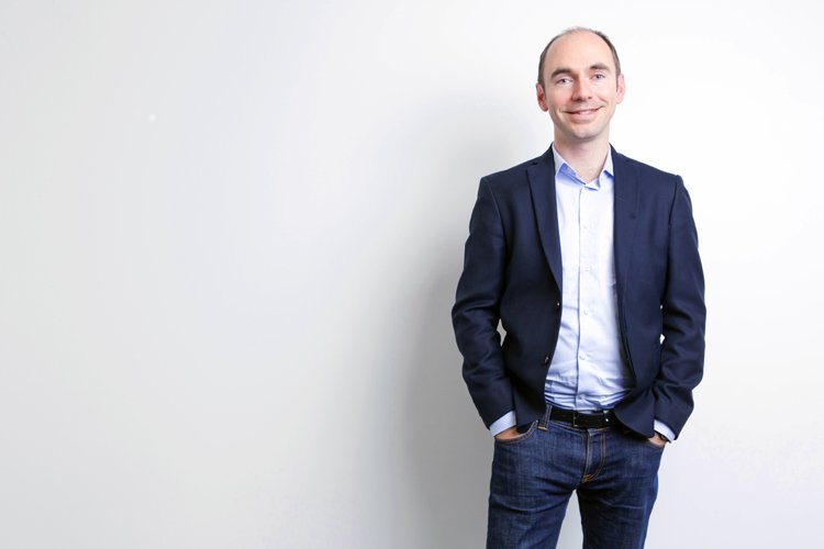 Businessman contemplating currency strategies for SMEs in finance - Global Banking & Finance Review