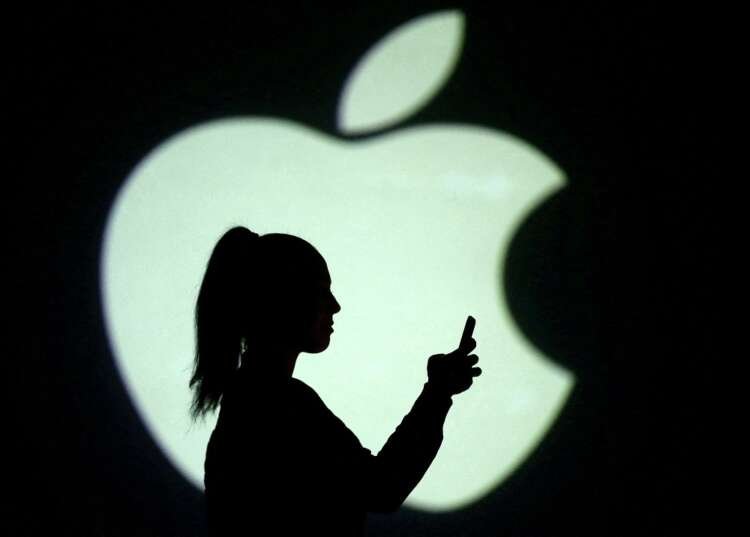 Silhouette of a mobile user with Apple logo, reflecting company's sales halt in Russia - Global Banking & Finance Review