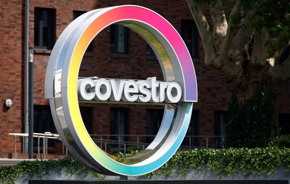 Covestro and ADNOC logos symbolizing merger talks for cost cuts - Global Banking & Finance Review