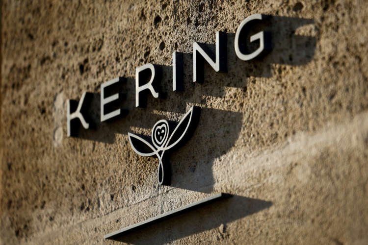 Kering logo displayed prominently, symbolizing luxury acquisition of Creed fragrance - Global Banking & Finance Review