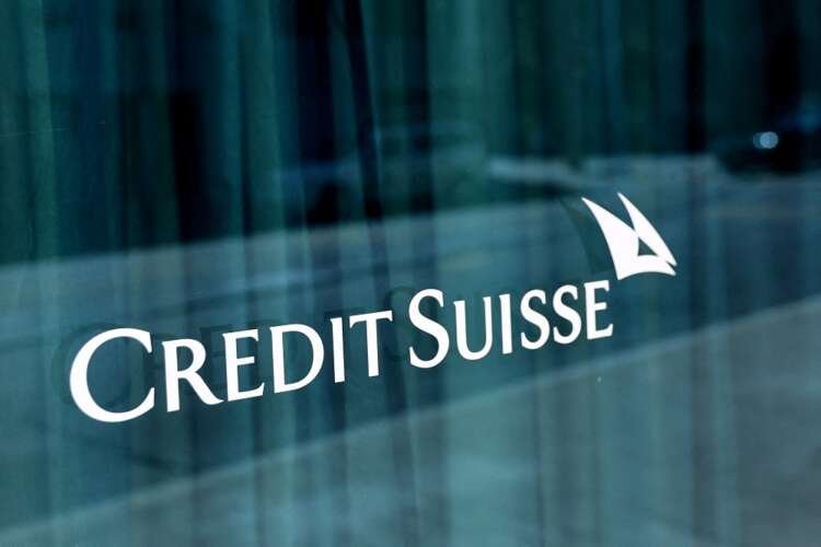 Credit Suisse logo on bank building, symbolizing AT1 bond redemption - Global Banking & Finance Review