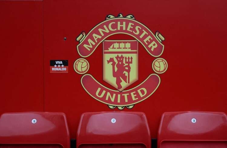 Manchester United logo during a match, reflecting financial struggles - Global Banking & Finance Review