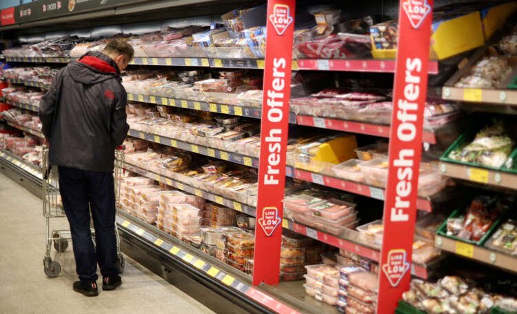 A shopper navigating the meat aisle in a supermarket amid rising inflation - Global Banking & Finance Review