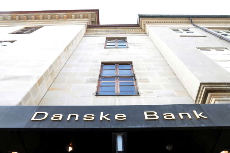 Danske Bank logo with financial graphs showcasing positive quarterly profit - Global Banking & Finance Review