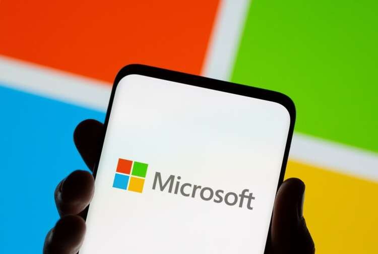Microsoft logo displayed on a smartphone, symbolizing business cutbacks in Russia - Global Banking & Finance Review