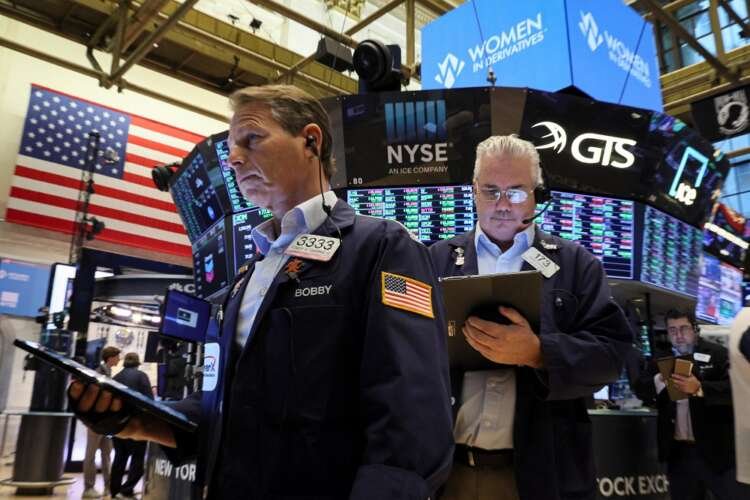 Traders work on the floor of the NYSE in New York