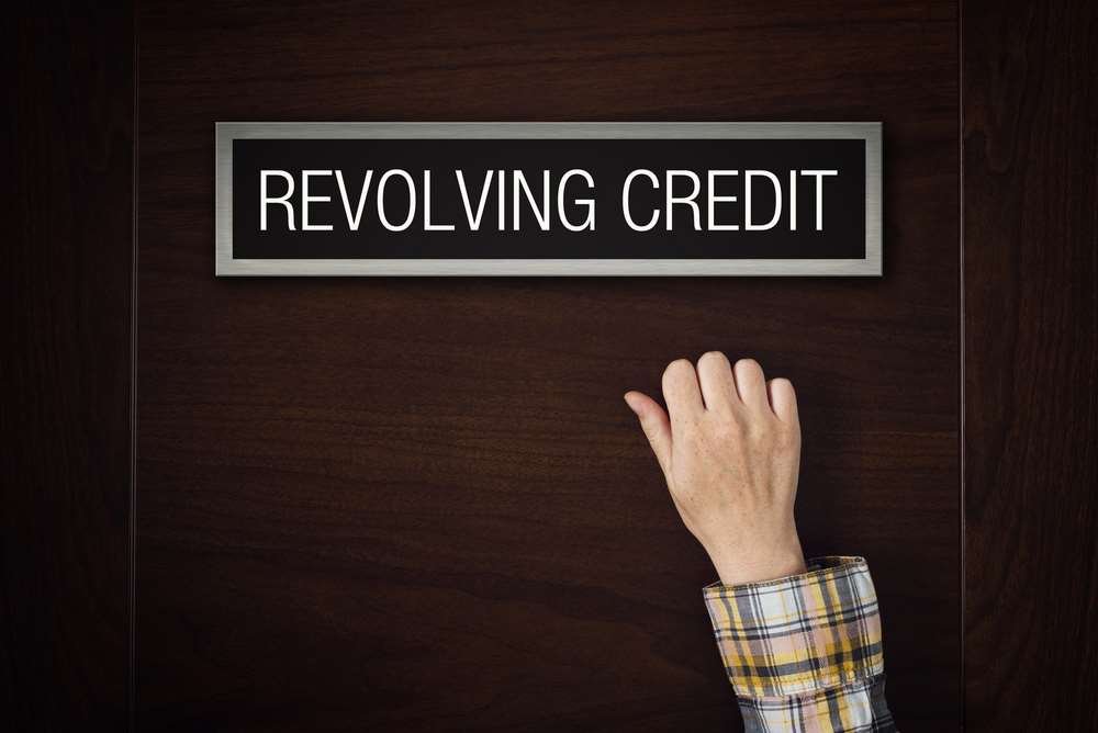 Person analyzing revolving credit options on a digital device - Global Banking & Finance Review