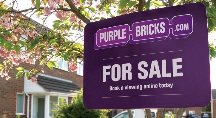 Purplebricks for sale sign outside a property representing the hybrid estate agency model - Global Banking & Finance Review