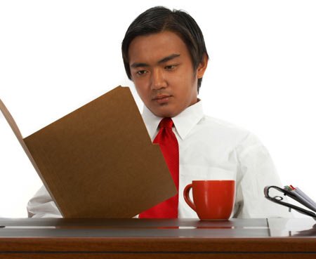 Office worker reviewing legal documents related to compliance with foreign court orders - Global Banking & Finance Review