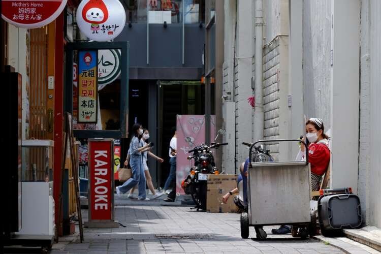 Employee resting outside during COVID-19 restrictions in Seoul - Global Banking & Finance Review
