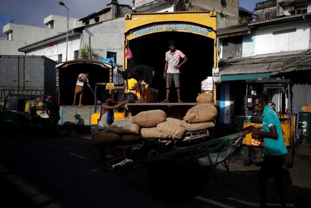 Laborers unload rice sacks at a market, highlighting Sri Lanka's food shortage crisis - Global Banking & Finance Review