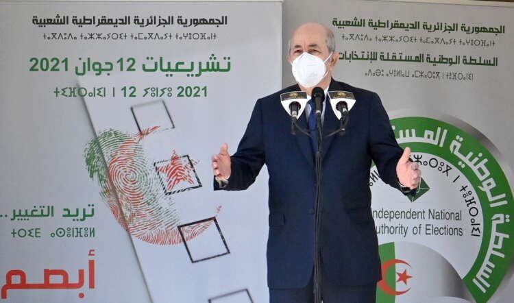 FILE PHOTO: Algeria’s President Abdelmadjid Tebboune speaks outside a polling station during the country’s parliamentary election in Bouchaoui