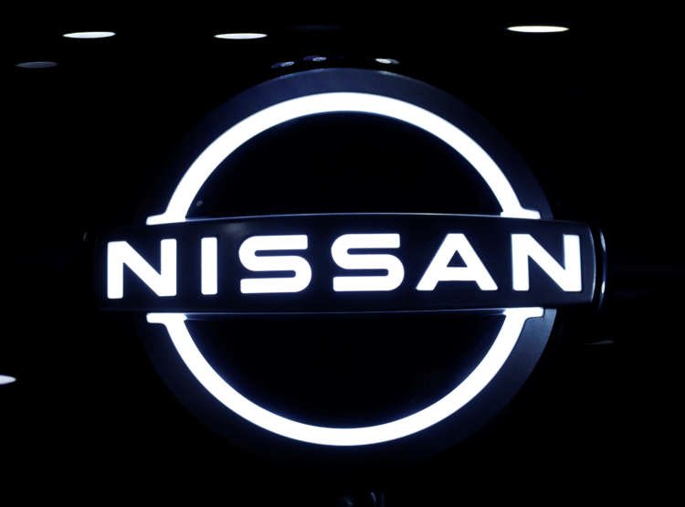 The brand logo of Nissan Motor Corp. is seen at the front nose section of the company’s new Ariya all-battery SUV during a press preview in Yokohama