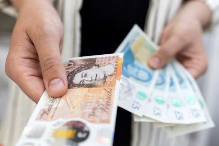 Close-up of British Pound banknotes representing UK economic challenges - Global Banking & Finance Review