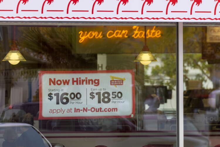 FILE PHOTO: An In-N-Out Burger advertises for workers at their restaurants location in Encinitas, California
