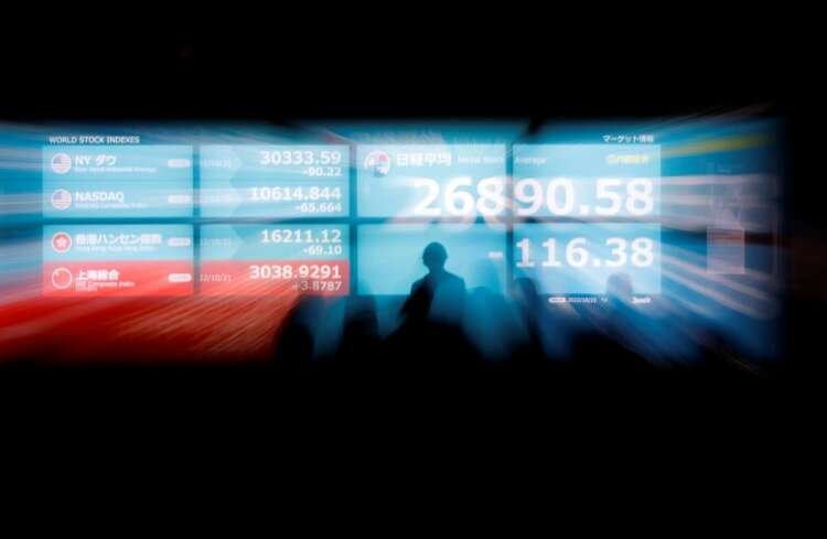 View of Tokyo stock market monitors reflecting mixed global market trends - Global Banking & Finance Review