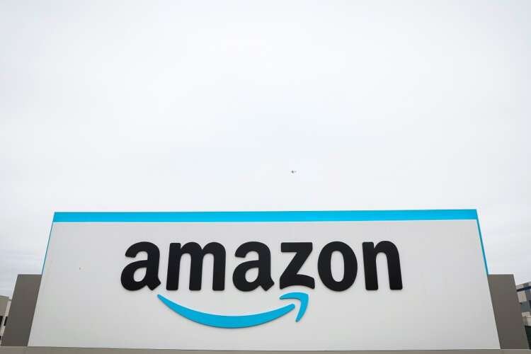 Amazon logo displayed outside a sortation center, highlighting UK probe over anti-competitive practices - Global Banking & Finance Review