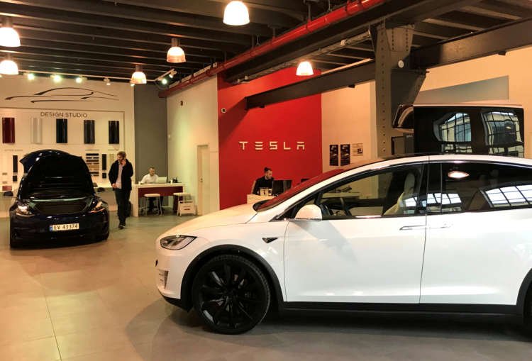 Tesla electric cars displayed in a showroom, symbolizing new manufacturing unit in India - Global Banking & Finance Review