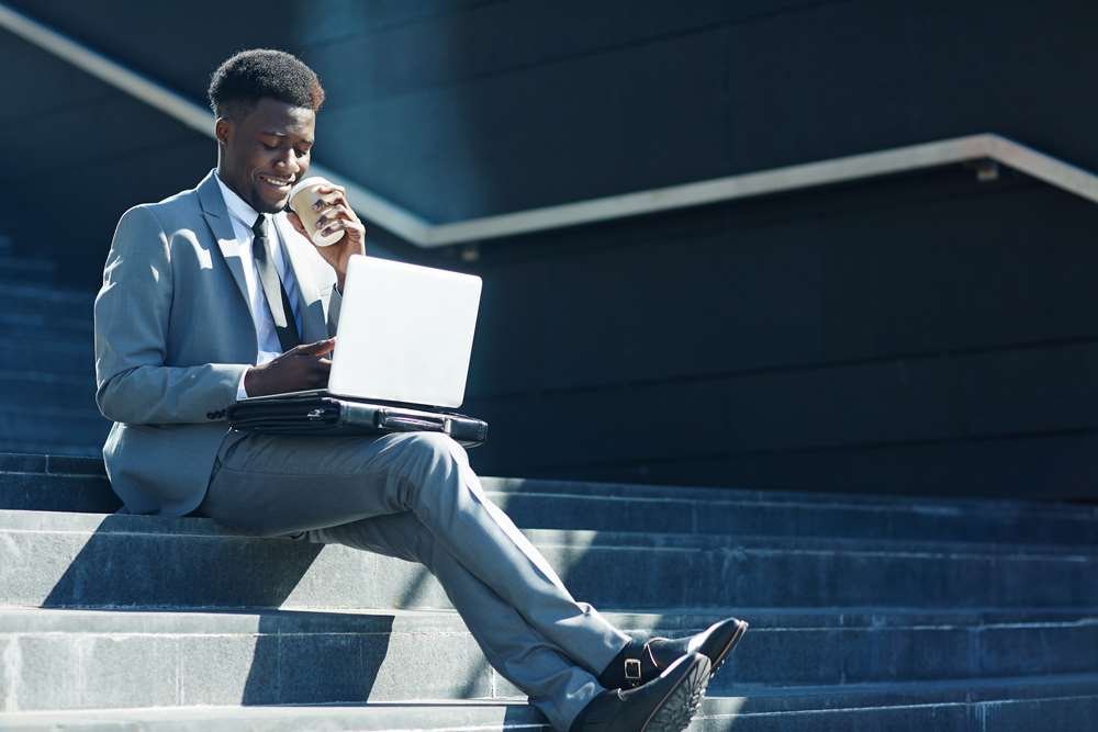 Trader working remotely with a computer and charts during COVID-19 - Global Banking & Finance Review