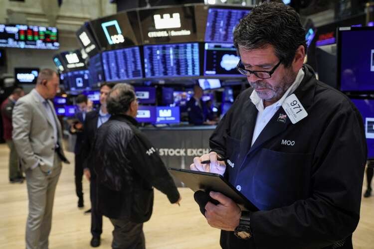 Traders work on the floor of the NYSE in New York