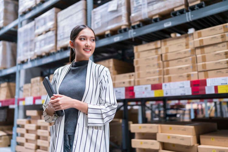 Asian female business owner managing inventory in a warehouse - Global Banking & Finance Review