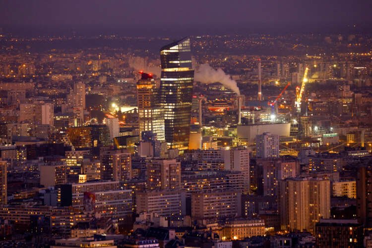 View of Paris with Tours Duo and smokestacks, highlighting air pollution issues - Global Banking & Finance Review