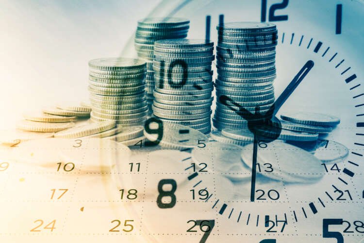 Double exposure of coins with a clock and calendar, representing banking's shift to real-time data - Global Banking & Finance Review