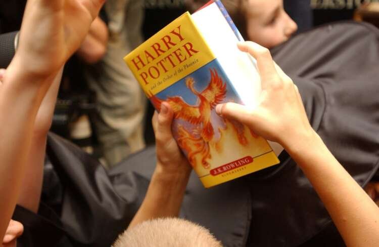 Child holding a Harry Potter book, symbolizing Bloomsbury's publishing success - Global Banking & Finance Review