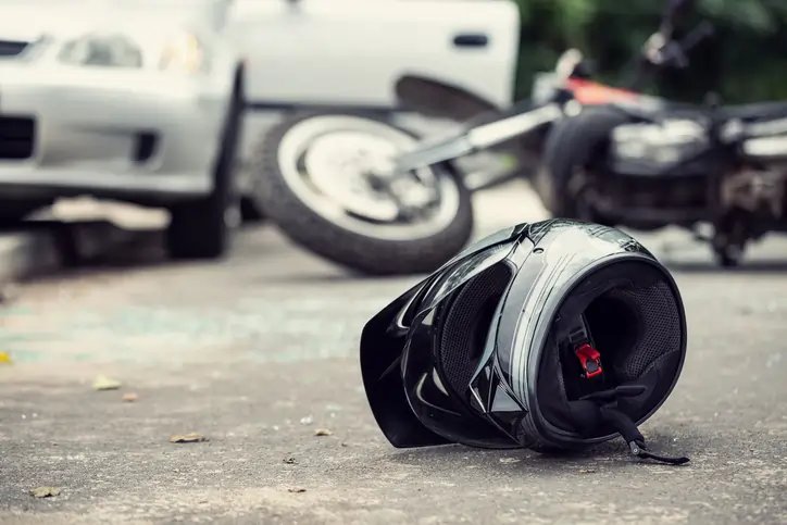 Motorcycle crash aftermath showing damaged bike and medical bills - Global Banking & Finance Review