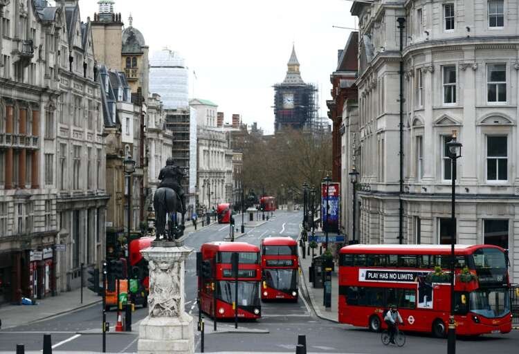 Buses on Whitehall in Westminster, highlighting UK's transport investment - Global Banking & Finance Review