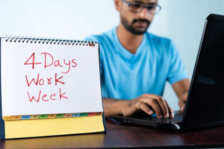Young man working with a calendar, symbolizing the four-day work week concept in finance - Global Banking & Finance Review