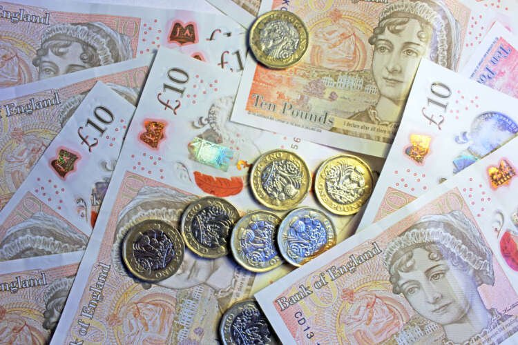 Close-up of UK coins and banknotes representing financial trends in 2023 - Global Banking & Finance Review