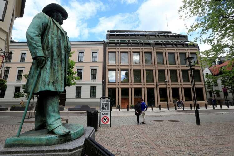 People walking near Norway’s central bank amidst rising inflation concerns - Global Banking & Finance Review