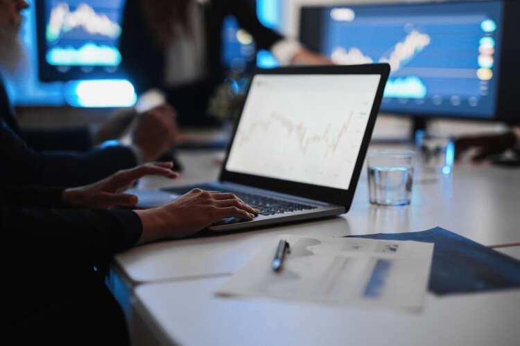 Multi-generational team analyzing currency hedging strategies in a finance office - Global Banking & Finance Review