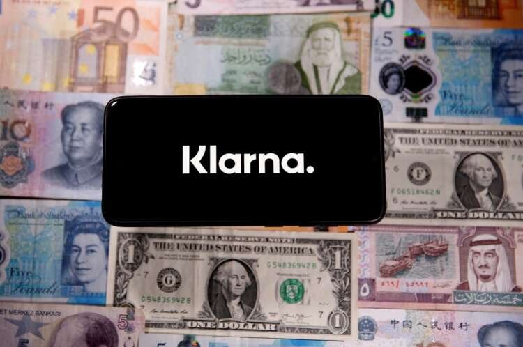 A smartphone displaying the Klarna logo over banknotes, symbolizing Buy Now Pay Later trends - Global Banking & Finance Review