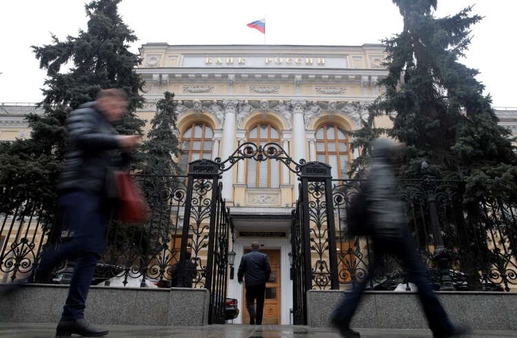 People walking past the Central Bank of Russia as rouble skids to record low - Global Banking & Finance Review