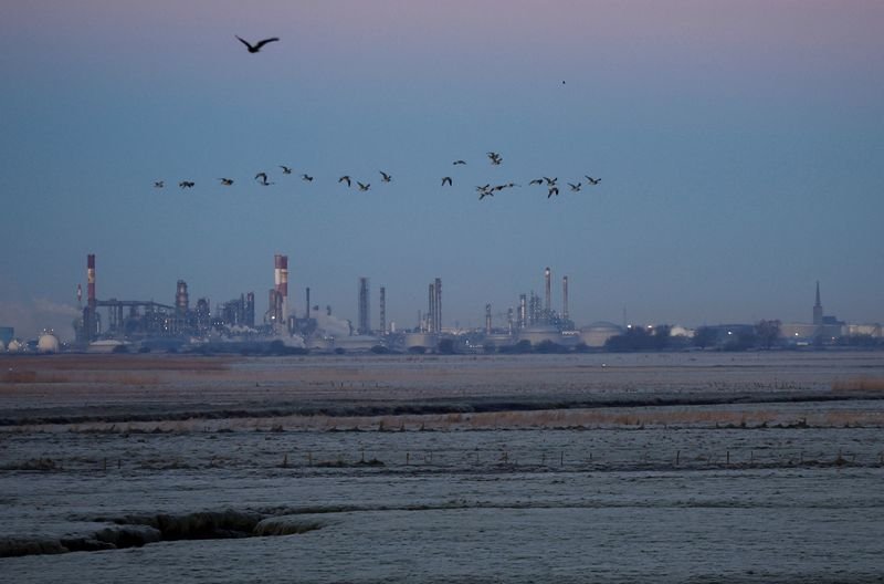 TotalEnergies logo with financial graphs illustrating Q4 profit results - Global Banking & Finance Review