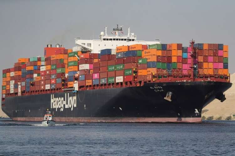 Shipping containers navigating the Suez Canal, crucial for global trade - Global Banking & Finance Review